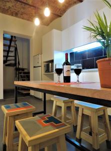 a kitchen with a table with two glasses of wine at Stylish duplex in Caseros Boulevard - San Telmo in Buenos Aires