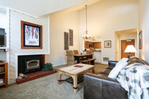 a living room with a couch and a fireplace at Aspen Creek #311 condo in Mammoth Lakes