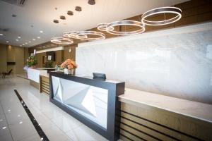a lobby with a reception counter with a large window at Lintas Platinum Hotel in Kota Kinabalu