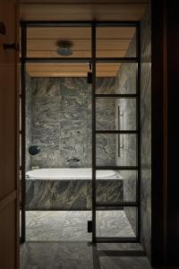 a bathroom with a bath tub in a room at Park Hyatt Kyoto in Kyoto