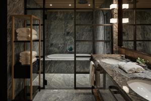 a bathroom with two sinks and a tub at Park Hyatt Kyoto in Kyoto