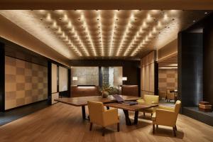 a dining room with a table and chairs and a ceiling at Park Hyatt Kyoto in Kyoto