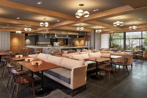 a restaurant with tables and chairs and a bar at Park Hyatt Kyoto in Kyoto