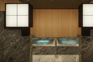 a room with a swimming pool with two windows at Park Hyatt Kyoto in Kyoto