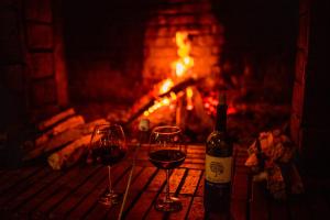 
a fire place with many bottles of wine at Hotel Rancho Constanza in Constanza
