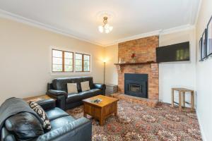 a living room with a couch and a fireplace at Mason Winery in Mount Tamborine