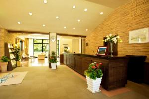 a lobby with a reception desk with flowers on it at Hotel Hakuba in Hakuba