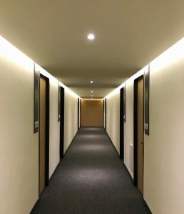 a hallway of a building with doors and lights at Hotel Conde Alameda CDMX in Mexico City