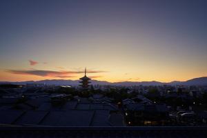 a view of a city at sunset with roofs at Park Hyatt Kyoto in Kyoto