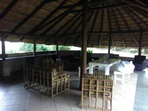 a patio with a table and chairs under a pavilion at Country Rose in Hluhluwe