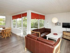 a living room with a couch and a table at 8 person holiday home in Hj rring in Hjørring