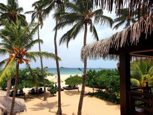 a view of the beach from a resort with palm trees at Nilaveli Beach Resort - Level 1 Certified in Nilaveli