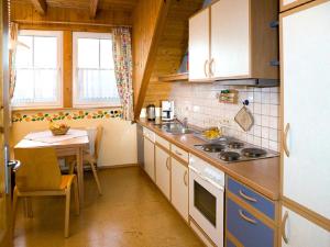a kitchen with a table and a stove top oven at Franzenhof Markhart in Deggenhausertal