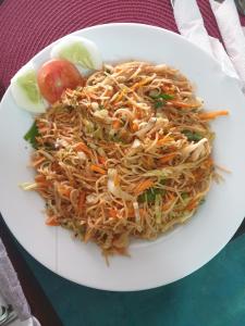 a white plate of food on a table at The Bed in Hikkaduwa