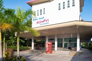 a red phone booth in front of a building at Eco Inn Lite Chanthaburi in Chanthaburi +21 photos