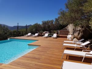 a swimming pool with lounge chairs and a swimming pool at Hotel A Piattatella in Monticello