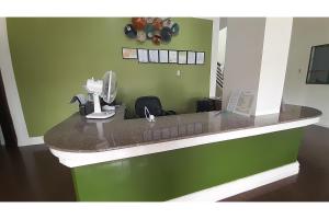 a kitchen with a counter with a hair dryer at Adelaida Pensionne Hotel in Bantayan Island