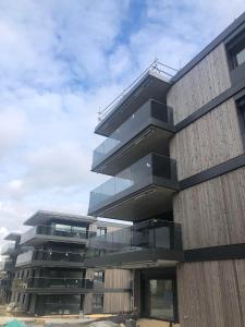 a building with balconies on the side of it at Appartement Daria Cossonay in Cossonay