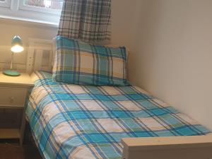 a bed with a pillow on top of it in a room at Hollybrae house Sleeps up to 6 in Kirkcaldy