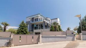 duży dom z płotem przed nim w obiekcie Luxury villa Nicol with pool and sea view 300m from the beach w Puli