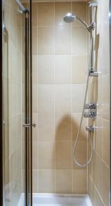 a shower with a glass door in a bathroom at The Pennington Hotel in Ravenglass