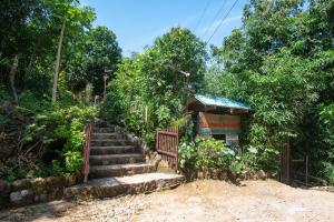 a set of stairs leading to a small building at La Estancia Busuanga in Busuanga