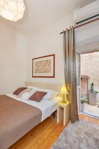 a bedroom with a large bed and a window at Hidden Gem Old Town in Dubrovnik