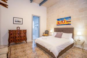a bedroom with a large white bed in a room at Harbour Heights in Valletta