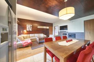 a dining room and living room with a table and chairs at Tahko Spa Hotel in Tahkovuori