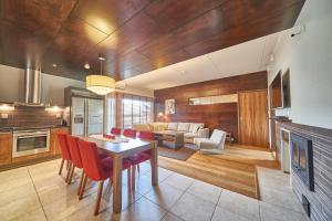 a kitchen and living room with a table and chairs at Tahko Spa Hotel in Tahkovuori