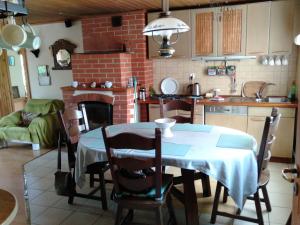 a kitchen with a table and a kitchen with a fireplace at Dwa jeziora in Wejsuny