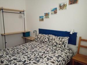 a bedroom with a bed with a black and white comforter at I Cavalieri di Malta in Palermo