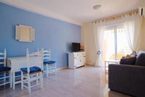 a blue living room with a table and chairs at Sea Front Voramar fibra WiFi in Calpe