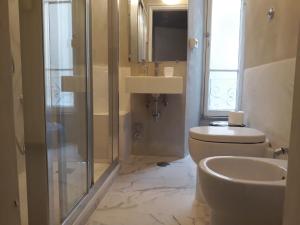 a bathroom with a toilet and a sink and a shower at 2 Be Home Colosseo in Rome