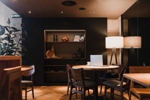 a dining room with a table and chairs and a lamp at Hotel Kramer in Valencia