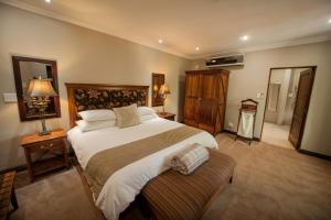 a bedroom with a large bed in a room at Fairview Hotels,Spa & Golf Resort in Tzaneen