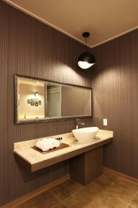 uma casa de banho com um lavatório e um espelho em S& Hotel em Daejeon