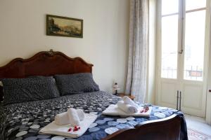 1 dormitorio con 1 cama con toallas en I Cavalieri di Malta, en Palermo