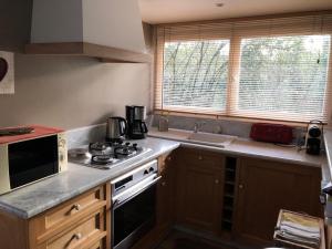a kitchen with a stove and a sink at La Source in Condette