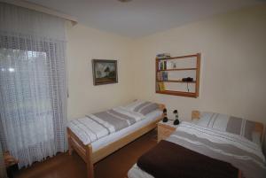 a bedroom with two beds and a window at Ferienhaus Hermann, 35522 in Uplengen