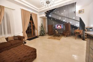 a living room with a couch and a christmas tree at Hotel La Belle Epoque in Petroşani