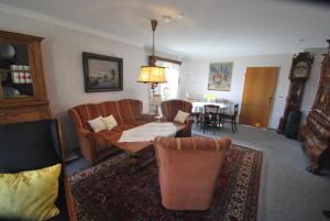 a living room with a couch and a table at Ferienhaus Hermann, 35522 in Uplengen