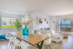 a dining room with a table and chairs at YupiHome Villa Alcanada - Family only in Port d'Alcudia