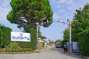 a sign for a building with a sign for auryury at Butterfly Camping Village in Peschiera del Garda