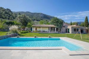a swimming pool in a yard with a house at Villa Son Beltran Valldemossa in Valldemossa