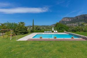 a swimming pool in a yard with mountains in the background at Villa Son Beltran Valldemossa in Valldemossa