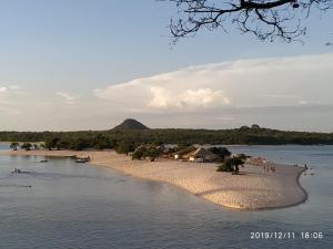 a group of people on a beach in the water at Alter do chão Caribe do Norte in Alter do Chao