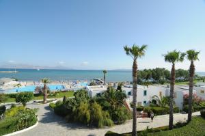 a view of a resort with palm trees and the ocean at Mastichari Bay Hotel in Mastihari