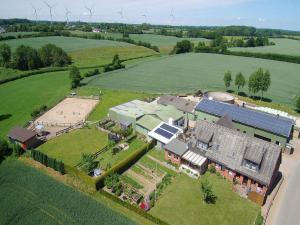 an aerial view of a large house in a field at Ferienwohnung an der Au in Taarstedt