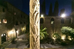 un palo di fronte a un palazzo di notte di Hotel La Badia di Orvieto a Orvieto